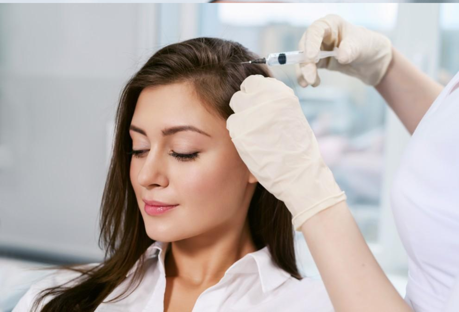 Woman receiving hair restoration treatment with a syringe in a medical spa setting, highlighting aesthetic and wellness services.