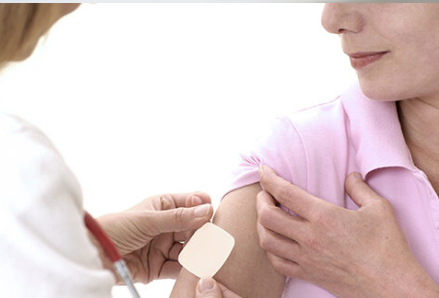 Woman receiving a medical treatment, showcasing a nurse applying a bandage on her arm, emphasizing wellness and clinical care at Skin & Body Med Spa.