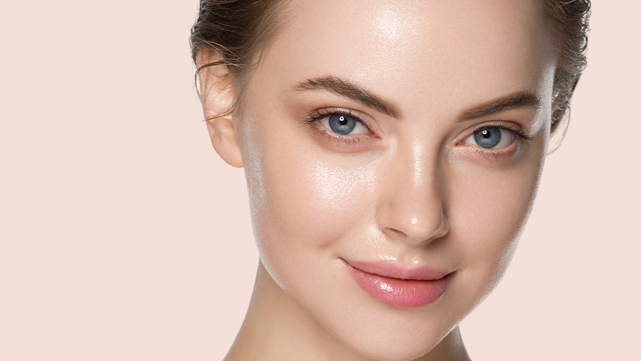Close-up of a woman with glowing, hydrated skin and a natural makeup look, highlighting the benefits of clinical-grade facial treatments and wellness memberships at Skin Body Med Spa.