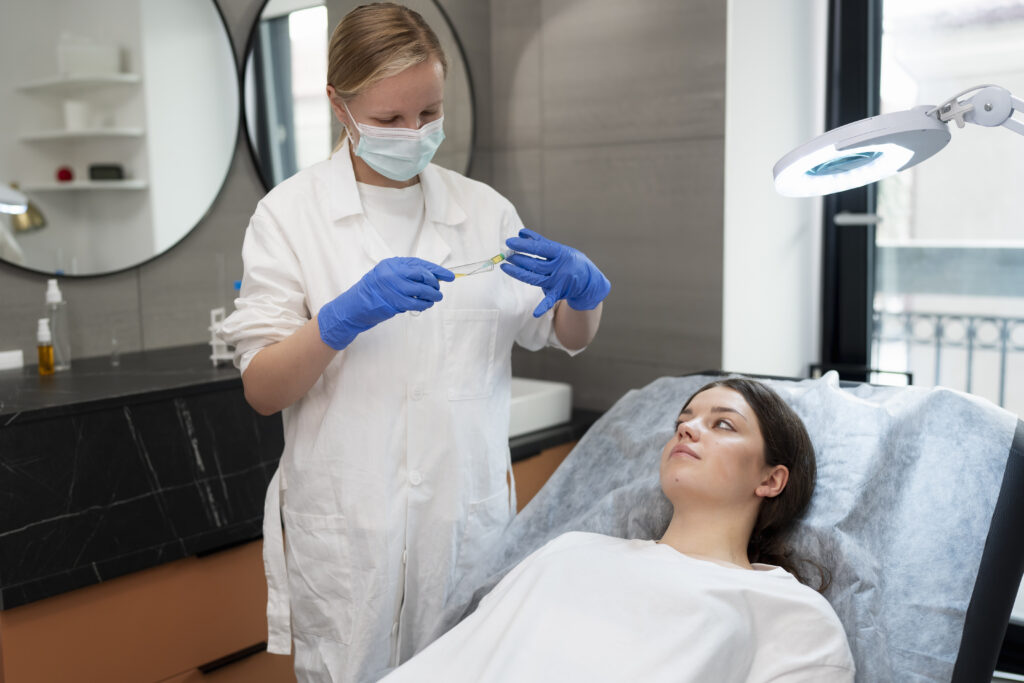 Young woman receiving PRP treatment in a medical spa, practitioner preparing syringe, modern aesthetic setting, focus on personalized healthcare services.
